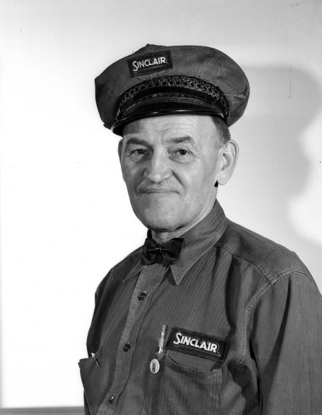 Portrait of Joe Cerny, owner of Cerny's Super Sinclair Service Station at 202 North Hamilton Street, wearing his Sinclair Service Station uniform.