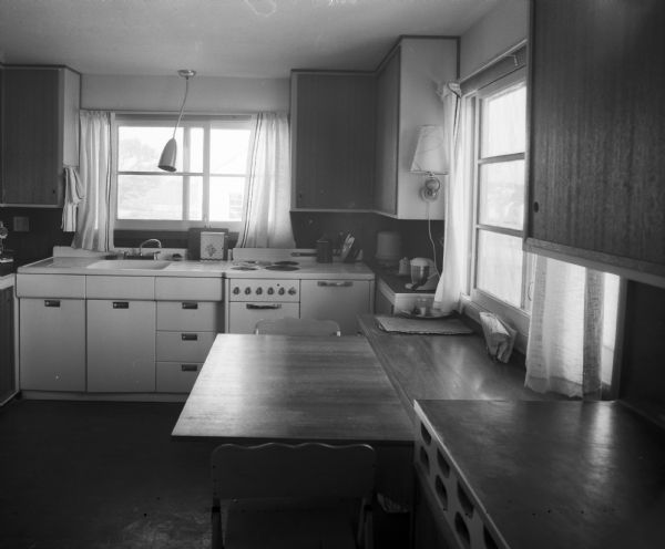 View of a Mid-Century modern kitchen with built-in features, including a slide out table inside the home of Ernst Friedlander. The house was owner-designed and located at 62 Merlham Drive.