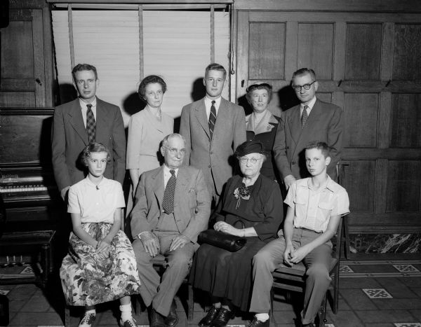 Emil J. Frautschi, prominent Madison business, church, and civic leader, shares his day of honor at the Rotary Club meeting with members of his family. Seated, left to right, are: granddaughter Barabra; Emil Frautschi; Emil's wife, Ida L.; and grandson Tim. Standing, left to right, are: Emil's son, Lowell E.; Lowell's wife, Grace M.; grandson Jerry; Mrs. Walter (Dorothy J.) Frautschi; and son Walter.