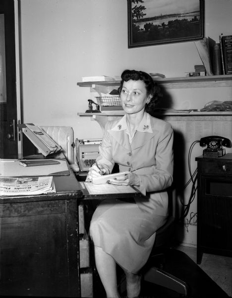 Edith Kramer, of 325 West Main Street, sits at a desk in the office. She is the private secretary to Madison Mayor George Forster.