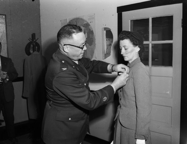 The Distinguished Service Cross for heroism was given posthumously to Capt. Robert Walker, Lancaster, who was killed as the result of heroic action near Sangju, Korea on Sept. 24, 1950.   Mrs. Thelma Walker, 4267 Mohawk Dr., is shown receiving the nation's second highest military honor from Col. Walter D. Tobin, senior army instructor of the Wisconsin national guard at the colonel's Truax Field headquarters.