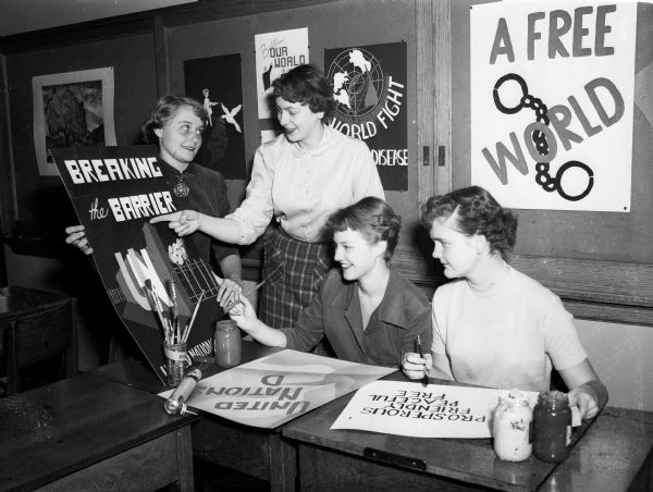 Students in a West High School art class make posters to commemorate United Nations Day and to be distributed to business and public places by the League of Women Voters. Shown left to right: Ann Winn, Cynthia Rhodes, Karen Cristofferson, and Jean Green.