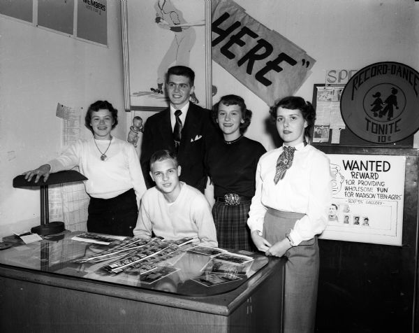 New officers for the Loft are shown in the headquarters at the Madison Community Center.  Standing, left to right, are Barbara Arvold, 174 Ryan Street, recording secretary, East High School; Thomas Stephan, 2205 West Lawn Avenue, vice-president, West High School; Lorraine Emordeno, 913 College Court, corresponding secretary, Central High School; and Mary Alice McCormick, 1815 Madison Street, treasurer, Edgewood High School. Seated is Fred Frankey, 112 South Henry Street, president, Central High School.
