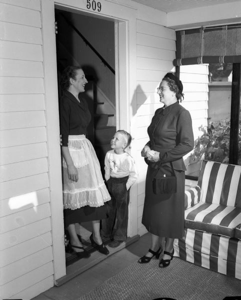 Mrs. J.H. (Mildred) Stumpf, United Giver's ward solicitor, at left, is shown calling on Adeline Johnson and her son, Stephan, age six, at 509 Elmside Boulevard seeking a donation. More than nine hundred volunteer workers are involved in a house-to-house canvas to solicit money for the 1951-52 United Givers' Fund. The fund represents twenty-two local, state, and national health and welfare agencies.
