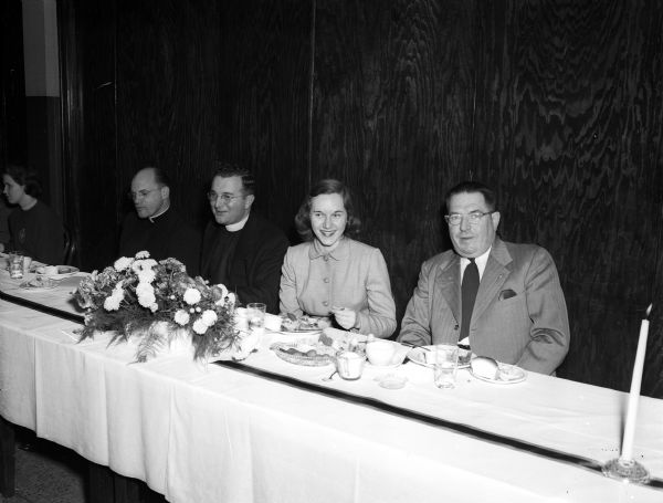 Seated at the speakers table of the Edgewood College father-daughter banquet are, left to right: Rev. John Beix of St. Francis Minor Seminary, Milwaukee; Rev. John Masterson, Edgewood College chaplain; Mary Ellen Burkhard and her father, John Burkhard, Monroe.
