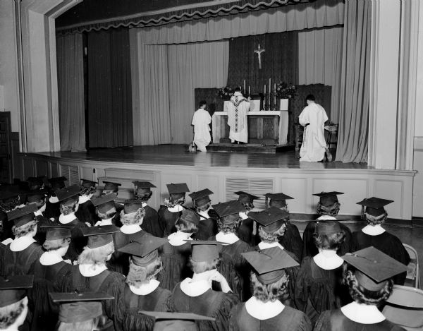 Mass is celebrated on the stage of the high school auditorium for Edgewood's 70th anniversary.