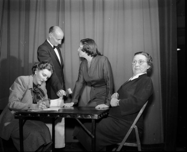 The "Old South" came to life as the Shorewood Hills Community League presented its minstrel show to Shorewood Hills residents and guests. The cast of a humorous skit about a fictional village board meeting includes Mrs. Nelson (Marjorie) Hagan, seated at left, and Mrs. J.T. (Annette) Schwab, seated at right. Standing are H.G Fraine, left, and Mrs. John W. (Jane) Byrns, right.