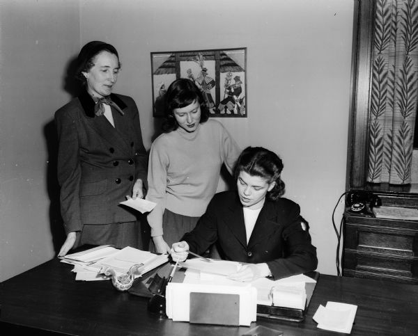 Members of the University of Wisconsin YWCA make plans for a luncheon. In the photograph are Jean Whittet, executive director of the University YWCA; Betty Hegg, president of the YWCA; and Grace Douma, assistant to the Dean of Women.