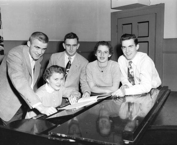 Committee chairmen for the Edgewood High School homecoming select music for the dance. From left, standing, are Tom Haen, Don Noltner, JoAnn Gilbert, and Morrissey Clark. Seated is Marilyn Mackesey.
