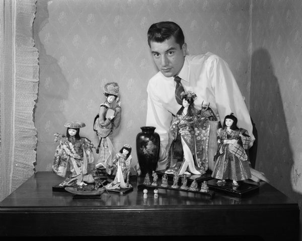 Joe Osterle, 2411 Monroe Street, is pictured with his collection of handmade Japanese dolls. Mr. Osterle, a Korean War veteran, collected the dolls and other Japanese and Korean handicrafts during his tour of duty in Korea, and a stopover in Japan on his way back to the United States.