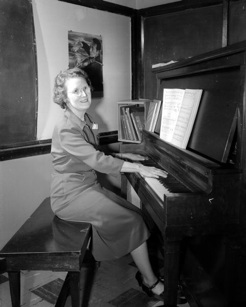 Portrait of Madison music teacher Gertrude Kellman, seated at a piano. Kellman teaches at Emerson School.