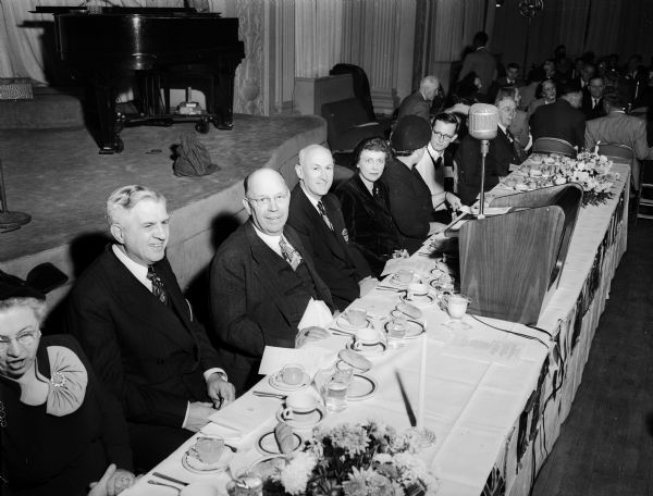 Seated at the main table at the Rotary Club's International Night Dinner are, from left: Methodist Church Bishop H. Clifford Northcott, Robert G. LeTourneau, Peoria, Ill., industrialist who gave the main address, Prof. Richard Conrad Emmons, club president; and Mrs. Pearl Emmons.
