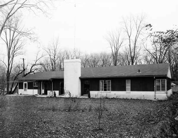 Exterior rear view of the Stewart and Jean Douglas house at 811 Farwell Drive in Maple Bluff.  The house includes some floor to ceiling windows, including two on the left and right of a fireplace.