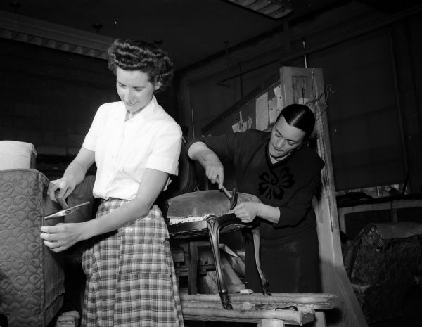Constructive Workshops for Older Adults, created by the Vocational School, offers many leisure time activities for newly retired men and women. Clara Gull and Catherine Key are pictured at work on their projects in the upholstering class.