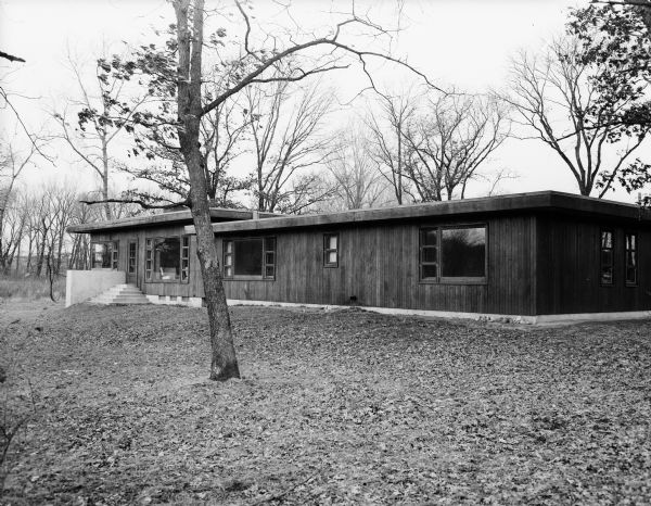 Exterior view of the David & Florence Bade residence at 5701 Winnequah Road in Frost Woods, Monona. The home is a rambling redwood bungalow they built themselves.