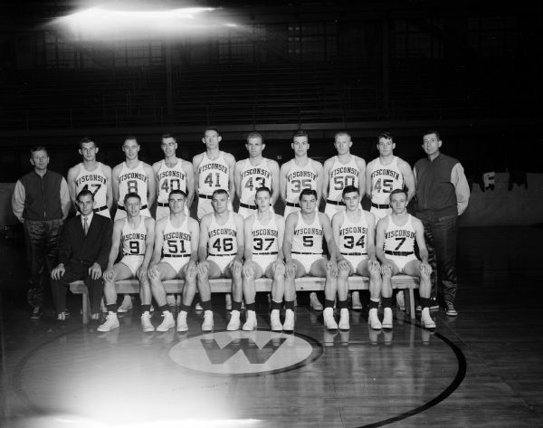 Group portrait of the University of Wisconsin varsity basketball squad with their two coaches.