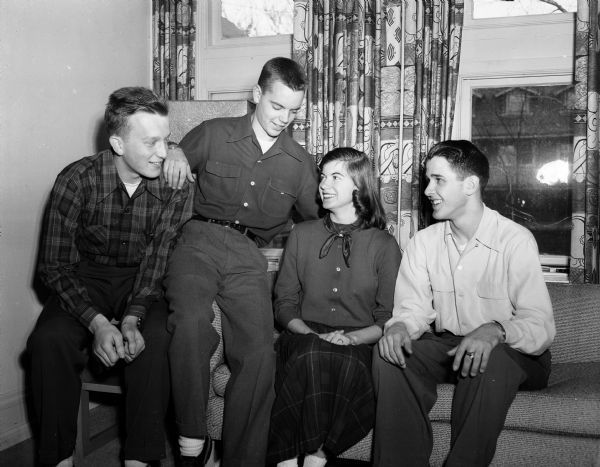 Members of the committee plan the University Club's annual Christmas dance for the children and grandchildren of club members and their friends. Seated, from left, are Henry Goehring, Ray White, Ann Ratcliff, and Norman Barton.
