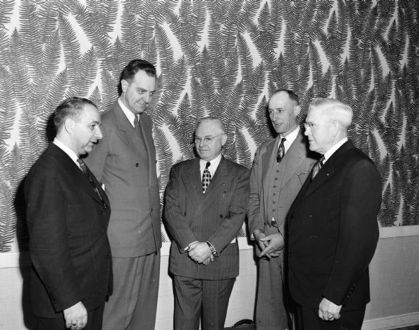 Participants in the organizational meeting of the Madison area 1952 Brotherhood Week observance discuss plans at a meeting in the Park Hotel. They are, left to right: Atty. Maurice Pasch, Madison, state co-chairman of the observance; Leo Bishop, Chicago, vice-president of the National Conference of Christians and Jews; Delbert Kenney, West Bend, state chairman of the observance; C.R. Mottley, Route 4, Mineral Point, Lafayette County chairman; and A.R. Campbell, Dodgeville, Iowa County chairman.