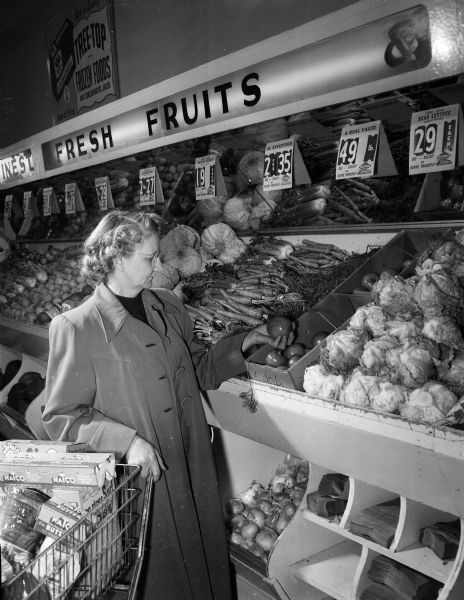 A woman shops for fruits and vegetables at the National Food Store in the Shorewood Shopping Center, located at 3244 University Avenue in Shorewood Hills.