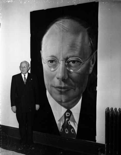Harvey Higley, Marinette, poses in front of a giant-sized campaign poster of Robert Taft in the presidential campaign headquarters at 117 South Webster Street. Mr. Higley is the chairman of the Bob Taft for President Committee in Wisconsin.
