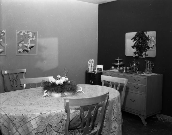 Dining room in the ranch-style home of Harold Baumgartner at 240 South Oak Street, showing dining table and chairs and a buffet.