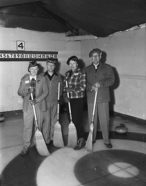 Mr. and Mrs. Bill Owens and Mr. and Mrs. William Mohr, members of the Bill Owens curling rink of Portage, posing at the second annual mixed bonspiel sponsored by the Portage Curling Club.