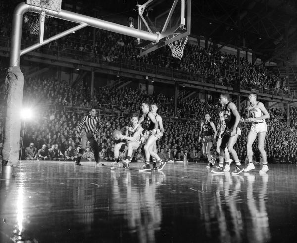 Action shot under the basket during the UW Purdue basketball game.