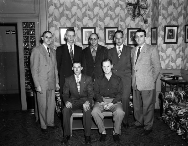 Group portrait of the newly elected officers of the Wisconsin Central Airlines Local No. 780, International Association of Machinists. Seated left to right: Darrell Brunner, vice-president, and Don Clausen, president. Standing left to right: Paul Seyer, financial secretary; Donald Brown, treasurer; Magnus Budzien, recording secretary; Walter Kneller, sentinel; and Paul Kristof, trustee.