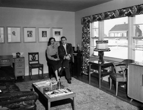 Living room of the William P. Robinson residence, located at 1923 North Avenue. Mr. and Mrs. Robinson are sitting before before the electric organ.