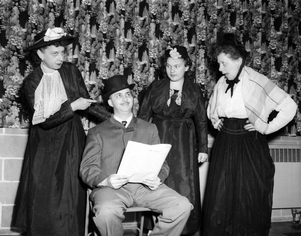 Four members of Trinity Lutheran church, 1904 Winebago Street, are shown in costume rehearsing the play "Our Town." The four cast members (shown left to right) are: Adelle Horalek, Chester Frederick, Diane Horalek, and Sally McCulloch.