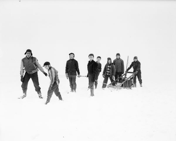 A group pulls a home-made Alaskan-type sled during the Boy Scouts Klondike at Glenway Golf Course.