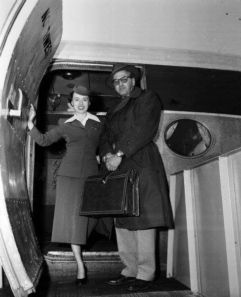 Roy L. Matson, editor of the Wisconsin State Journal, boarding a plane to start a 25,000-mile air tour of Europe and the Near East under the sponsorship of the United States Department of Defense. The stewardess for Northwest Airlines is S. Brosnahn.
