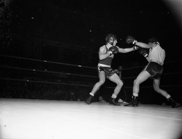 University of Wisconsin boxer Charlie Magestro (left) of South Milwaukee fights against Mitch Mazur of Detroit in a tournament at the University of Wisconsin-Madison Field House.