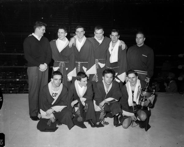 Group portrait of the nine winners of the championship finals in the All-University Wisconsin Boxing Tournament.
