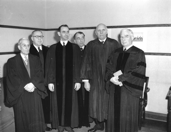 Group portrait of pastors and lay officials gathered for the installation of the Rev. John R. Collins, third from left, as the new pastor of the University Presbyterian church. They are, left to right: Rev. Arthur F. Wittenberger, Parkside Presbyterian Church; the Rev. Roy W. Zimmer, Christ Presbyterian Church; Mr. Collins; the Rev. Thomas R. Lyter, Washington Park Presbyterian Church, Milwaukee; Thomas H. Sanderson, chairman of the board of directors of the Presbyterian Student Center Foundation; and the Rev. Irwin F. Bradfield, executive secretary of the synod of Wisconsin.