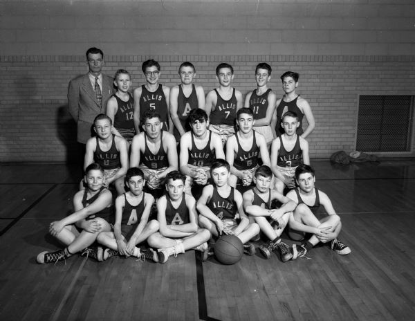 Group portrait of the Frank Allis grade school basketball team and their coach, Walter Barr, standing at the left in the top row. The team scored its fifteenth victory of the season in the Suburban Elementary School League.