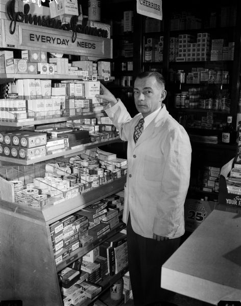 Portrait of Harland O. Hogan, registered pharmacist since 1937. Owner of Hogan's Pharmacy at 2250 Sherman Avenue and 4106 Monona Drive.