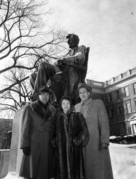 Representatives of three Republican organizations meet to plan the annual Lincoln Day dollar supper. Standing in front of the University of Wisconsin's statue of Abraham Lincoln on Bascom Hill are, left to right: Dr. Glen Eye, 438 Virginia Terrace, Dane County Republican Club; Mrs. A.R. (Norma) Meek, 813 Kings Way, Dane County Women's Republican Club; and Richard Stark, 2223 University Avenue, Young Republican Club.