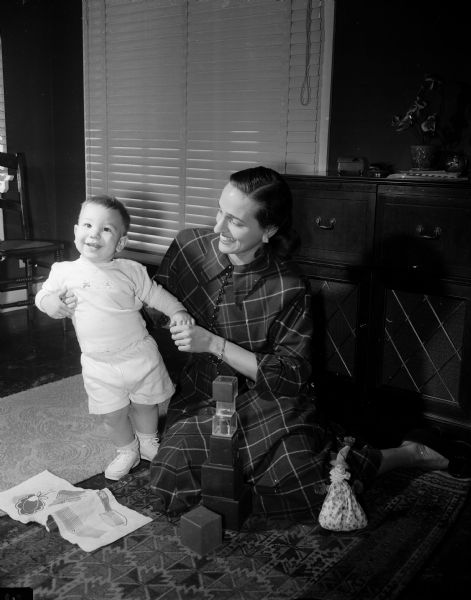 Shown are newcomers to Madison, Mrs. Edward Jacobs, 602 Pinchot Avenue, and her 14-months-old son, Mark.