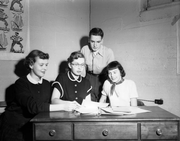 Making plans for a Junior Red Cross dance are, from right: Jeanne Rowley, Stoughton; Barbara Bruley; Don Schmitt; and Audrey Anderson, Stoughton.