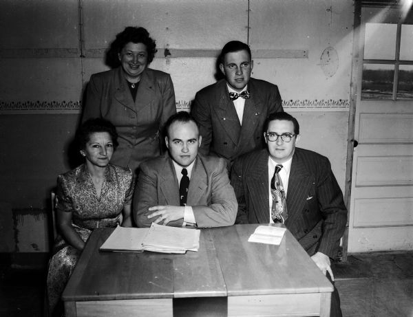 Group portrait of the officers of the Dane County 4-H Leaders Senior Council. Seated, from left: Mrs. Melfred Anderson, Waubesa, treasurer; Lyle Fosshage, Mt. Horeb, president; and Loyal Sargent, Monona, vice-president. Standing, left to right are: Olga Ottum, McFarland, historian; and Russ Weisensel, Sun Prairie, second vice-president.