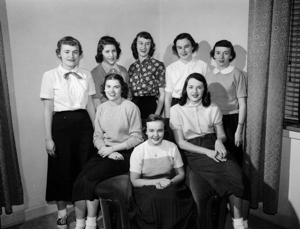 Group portrait of the Edgewood College committee planning the annual sophomore winter formal dance. Seated, left to right: Jo Ann Harwell, Sue Hunt, and Nancy Feeley. Standing: Peggy Swed, Marily Ludlow, Ruth Leuthner, Nancy Gallager, and Kay McDonouth.
