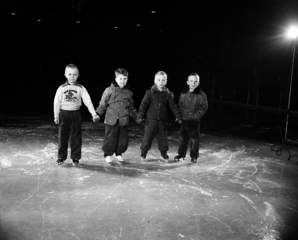 "The Four Horsemen," a quartet of little boys, are learning to ice skate at the Madison Skating Club at Truax Field.  Left to right: Jimmy Bakken, Phip Rieman, Bobby Beck, and Charles Cline.