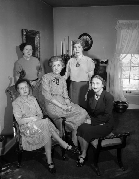Group portrait of some of the women of the Saint Catherine's Guild who are in charge of arrangements for the Annual Dessert and Style show at Grace Episcopal Church in the Vilas Guild Hall. Ruby Tuckwood, fashion co-ordinator at Harry S. Manchester, Inc., is the narrator for the syle show. Pictured left to right (seated), are: Mrs. John K. Shumate, Margaret Brown, Dorothy Rentschler, and standing are: Thelma Nystrom and Mrs. Charles Webster.
