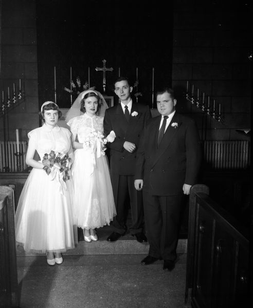 Jean Frances Sabin marries James Anders Pearce, son of Mr. and Mrs. Anders F. Pearce of Waukesha, in a ceremony performed by the bride's father, Rev. Edward Potter Sabin, at Saint Andrew's Church at 3 p.m. on Saturday. Pictured in the church from left to right are: Joan Hageman, a sorority sister of the bride and her maid of honor, Jean Frances Sabin, the bride; James Anders Pearce, the groom; and Theodore Raue, a fraternity brother of the groom and his best man.
