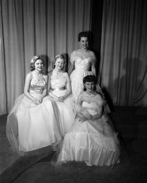 Group portrait of four University of Wisconsin women in formal dress, finalists in a contest for prom queen. Left to right: Phyllis Berg, Nancy Wetzel, Nancy Smith, and Donna Erickson.