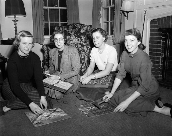 Four members of the Alpha Chi Omega Sorority make "self help" training boards to be used by spastic children being treated at the new Cerebral Palsy clinic at Wisconsin General Hospital. Left to right: Gail Turner, Molly Melham, Dorothy Uehling, and Patricia Pronix.