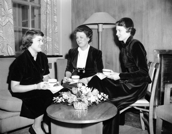 Members of the alumnae organization of Coranto Journalism Sorority entertained at a tea at the Memorial Union to honor University of Wisconsin journalism faculty and active chapter members. Shown left to right are: Janet Lucal, president of the active chapter; Mrs. E.T. Baltes, alumnae president; and Mrs. John Thompson, vice-president of the alumnae group.