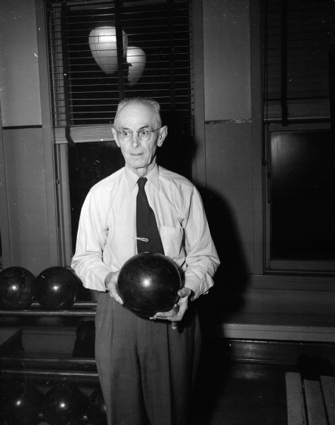 Portrait of Carl Minch, Belleville, who at 82 years of age is one of Madison's oldest active bowlers, pictured here at the Playdium Alleys in Madison. Minch has bowled in the Madison Knights of Columbus League for thirty-three seasons.