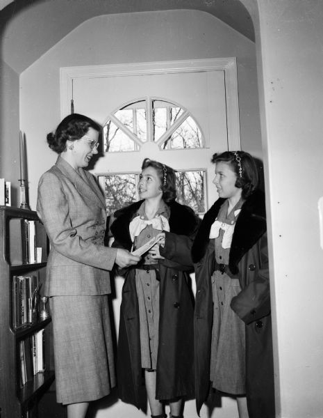 Girl Scouts Janet and Jane Brandenburg promote a Girl Scout cookie sale to Dorothy Freck.